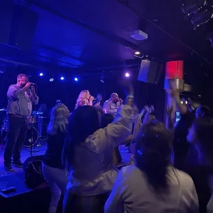 a group of people on stage at a concert