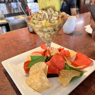 a plate of chips, watermelon, and avocado salad