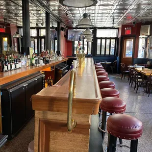a long bar with red stools