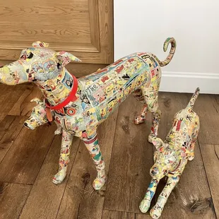 a dog and a cat made out of newspaper