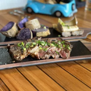 Steak, potato and mushrooms. The kids plate in the background comes in a fun vehicle.