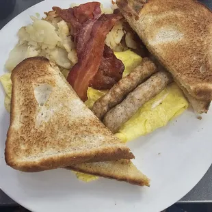 Eggs, bacon, sausage, home fries and toast.