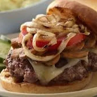 a hamburger with onions and cheese