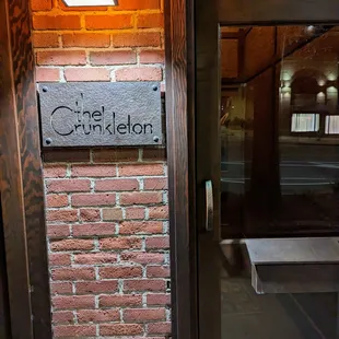 Outside. Entrance. Low key. Crunkleton sign by front door.