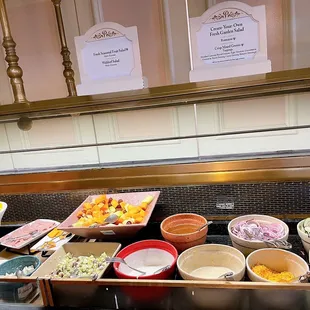 a buffet with many bowls of food