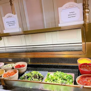 a buffet of salads and condiments
