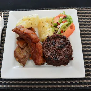 Fried Pork, congri rice, Garlic yuca and salad