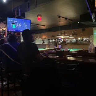 a group of people sitting at a bar