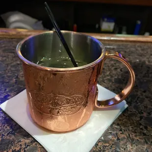 a copper mug with a spoon in it