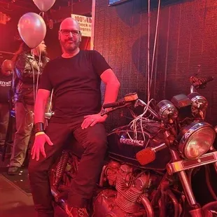 a man sitting on a motorcycle