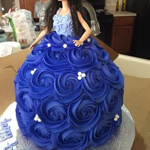 a barbie doll in a blue dress