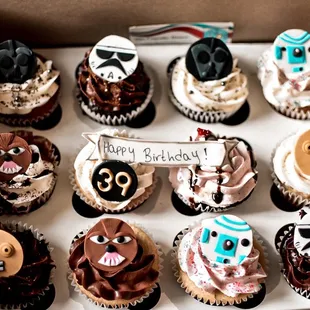 a box of decorated cupcakes