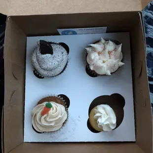 Oreo cupcake (top left) red velvet cupcake (top right) carrot cupcake (bottom left) and a mini vanilla cupcake (bottom right)