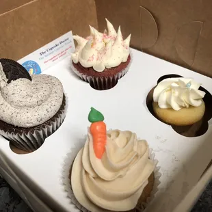 Oreo cupcake (left) red velvet cupcake (top) carrot cupcake (bottom) and a mini vanilla cupcake (right)