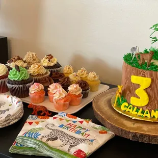 a birthday cake and cupcakes