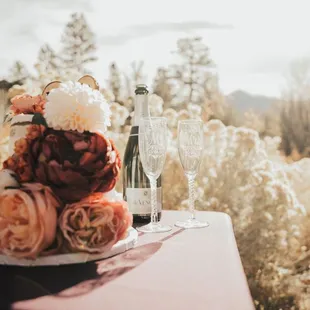 a glass of wine and a bouquet of flowers on a table