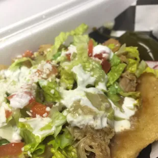 Sope de pollo. The toppings are very fresh. Includes beans and fresh cotija cheese. Yum!