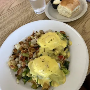 Veggie benedict with country potatoes and a biscuit on the side.