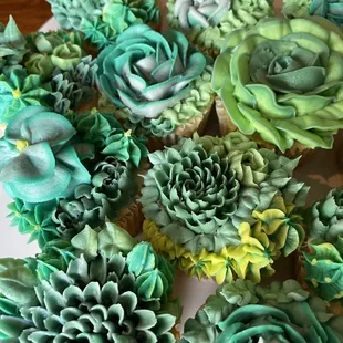 a plate of cupcakes decorated with flowers