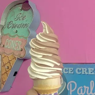 a hand holding an ice cream cone