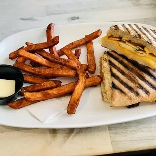 a grilled sandwich and french fries