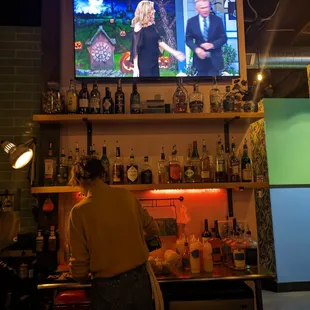 a man watching tv in a bar