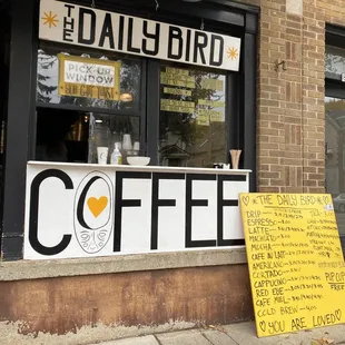 a sign outside of a coffee shop