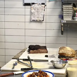 Kitchen, with smoked brisket waiting to be sliced.