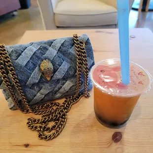 a drink and a purse on a table