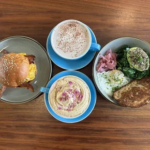 Breakfast sandwich, hot chocolate, upside down latte and loaded avocado toast