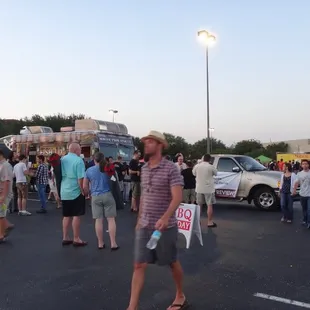 a crowd of people walking in a parking lot
