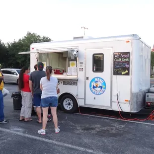 a group of people standing in a parking lot