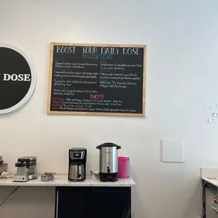 a coffee shop with a menu on the wall