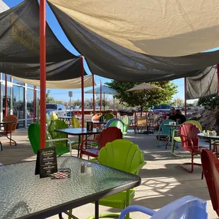 a patio area with tables and chairs