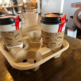 two coffee cups in a carton