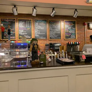a coffee shop with a brick wall