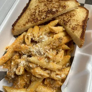Penne Bolognese served with Texas toast on the side to soak up all the leftover sauce