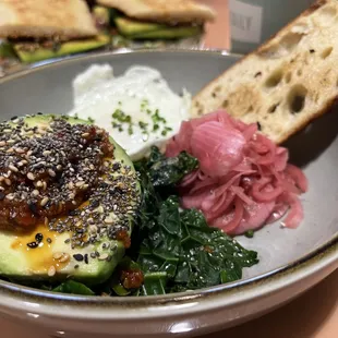 Loaded Avocado Vegetarian . Half Avocado, Over Easy Egg, Fennel Chili Crisp, Market Greens, Pickled Onion, Chives, toast - 11