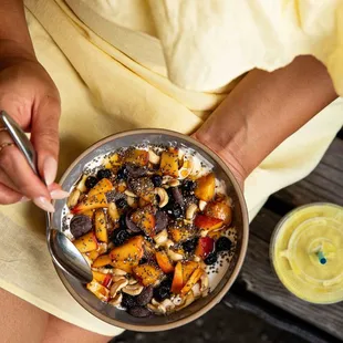 a woman holding a bowl of food