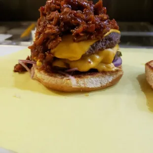 two burgers on a cutting board