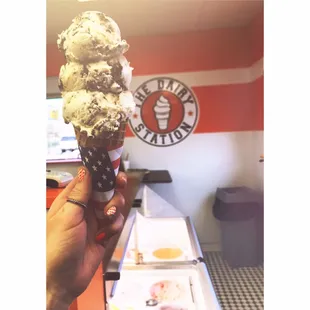 Triple scoop moose tracks on a waffle cone.