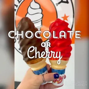 a hand holding two ice cream cones