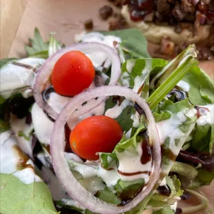 a salad with tomatoes and onions