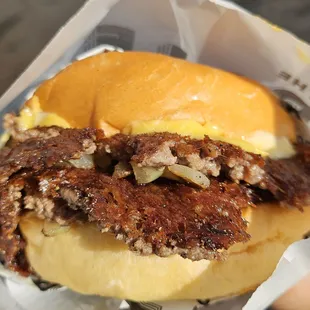 a hamburger with meat and cheese