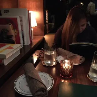 a woman sitting at a table in a restaurant