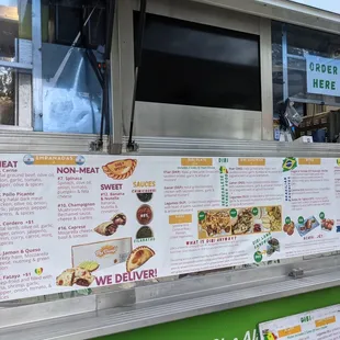 a menu on the side of a food truck