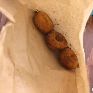 three donuts in a paper bag