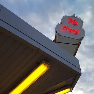 a neon sign on a gas station