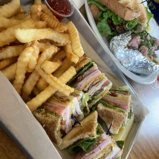 Club sandwich with fat fries