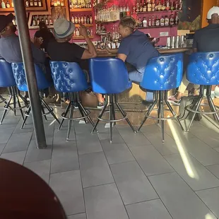 a group of people sitting at a bar